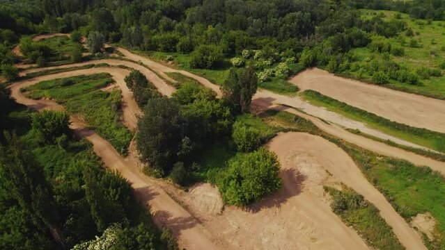 Aerial drone view of a rural landscape with a curvy dirt road like a labyrinth running through it near Warsaw, Poland. High quality 4k footage