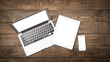 Laptop, smartphone and digital tablet on wooden background