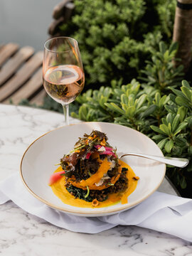 A puff pastry tart lunch with a glass of wine on a sun terrace. 