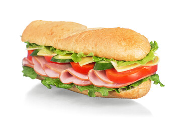 Long baguette sandwich with lettuce, vegetables, ham, and cheese on white background