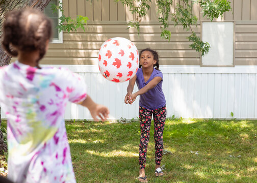 Kids Playing Volleyball With A Large Inflatable Pool Ball