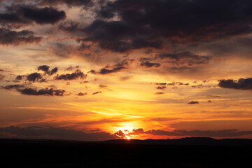 The sun sets on the prairies in the summer.