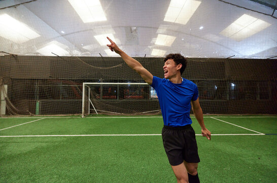 Happy football player celebrating victory