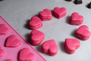 Obraz na płótnie Canvas Red Heart Macarons Dessert on Baking Parchment Paper