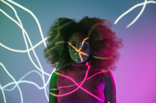 African American model under colorful neon illumination
