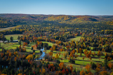 Fototapeta na wymiar Bird's eye view lookout over fall color trees and golf course in Bancroft, Ontario, Canada