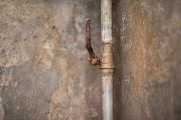 Grunge Metal Water Faucet. Rusted iron water valve control liver handled.