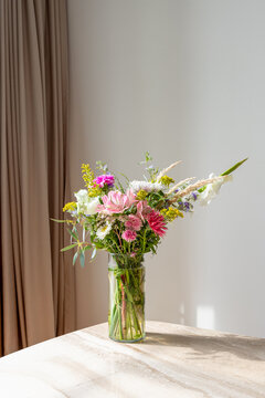 Beautiful flower arrangement bouquet on the marble table.