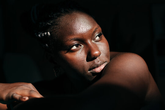 Portrait of a black woman with pimples and natural skin
