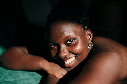 Smiling black woman with pimples and natural skin