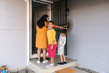 Mother and children entering home