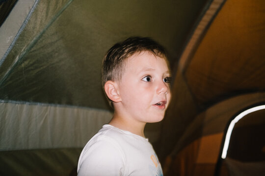 Boy excited in tent with direct flash