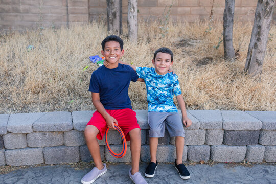 Children on stone bench outdoors portrait - Powered by Adobe