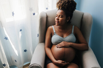 Calm pregnant woman sleeping on sofa