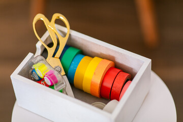 Colorful adhesive tapes and scissors inside box