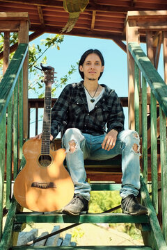 Portrait of a guitarist on wooden ladders