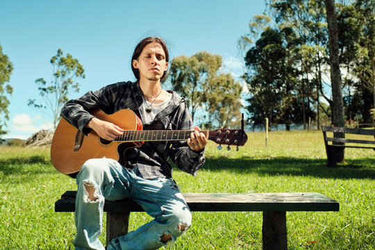 Concentrated musician playing guitar