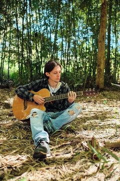 Musician playing guitar outdoors