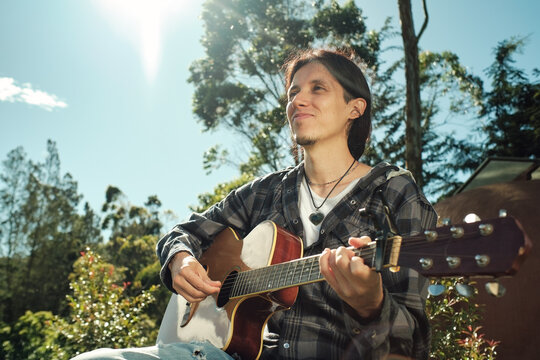 Portrait of smiling musician in the sunlight