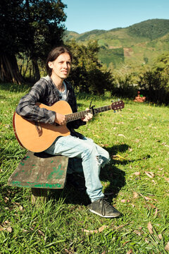 Side portrait of a guitarist on a sunny morning