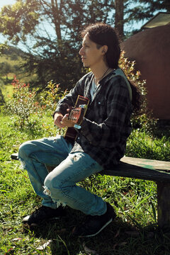 Latin musician sitting in the sunlight