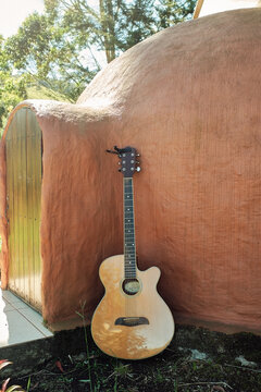 Guitar lying on a mud igloo