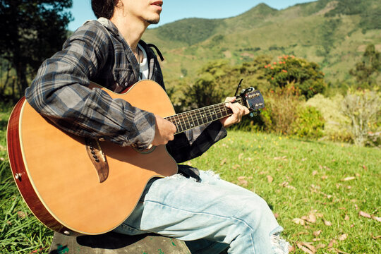 Unrecognizable musician playing guitar