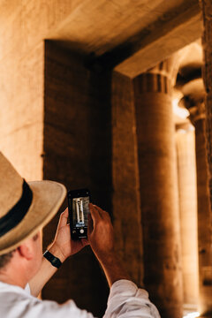 Tourist takingn photo of pillar in temple of Philae