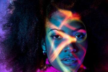 Serious black lady in purple neon studio