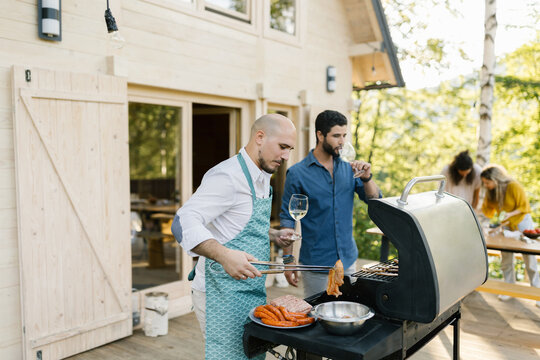 Friends Enjoying Preparing Barbecue