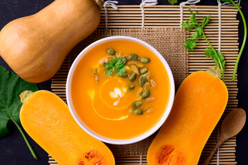 Butternut squash pumpkin soup in bowl, Homemade food in autumn season, Table top view