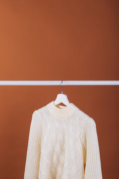 Single white sweater on a hanger
