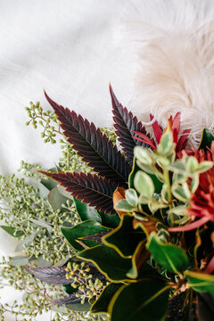 Moody autumn floral arrangement with colorful cannabis leaves