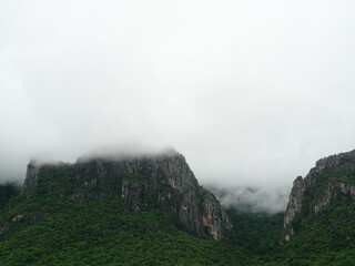 Cloud and fog cover limestone mountain in the rainy season, Green forest and rock at Khao Sam Roi Yot National Park, Thailand