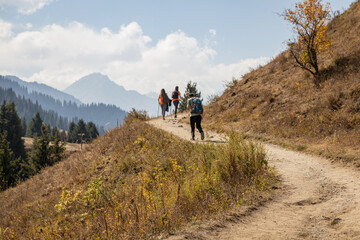 Young hikers walking in the mountains in Autumn.