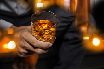 Closeup businessmen holding a glass of whiskey