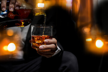 Closeup businessmen holding a glass of whiskey