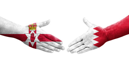 Handshake between Bahrain and Northern Ireland flags painted on hands, isolated transparent image.