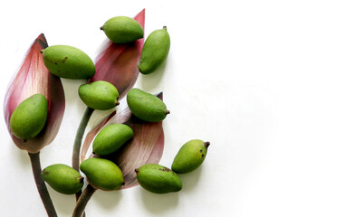 Small green mangoes on a wooden table