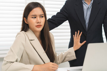 Unhappy, disgusted asian young employee, business woman defending hand of colleague, push out protect when boss touching her body, embrace shoulder. Sexual harassment inappropriate at office,workplace