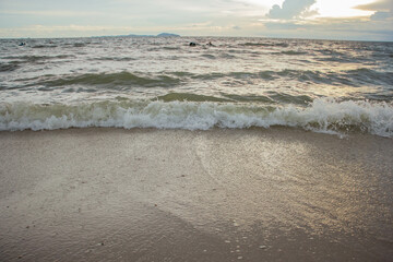 The beach the sea where the waves are hitting the shore Under the beautiful sky the sun is going...