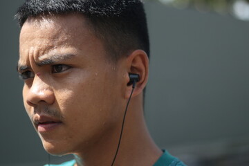 Young asian boy exercising and listening to music