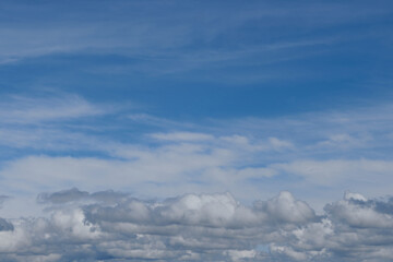 Cloudscape - blue sky and white clouds, wide panorama.