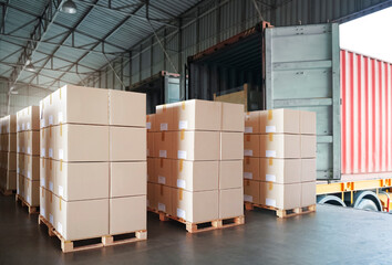 Packaging Boxes Stacked on Pallets Loading into Cargo Container. Delivery Shipping Trucks. Supply...