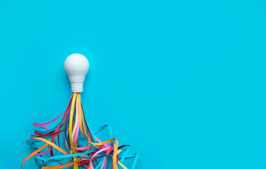 Ideas,inspiration concepts with rocket light bulb and colorful sparks on blue background