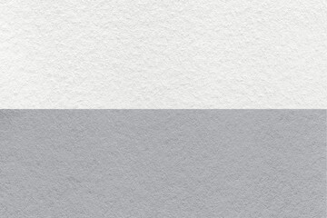 Texture of craft white and gray paper background, half two colors, macro. Structure of vintage dense grey cardboard.