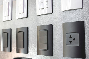 Various electrical outlets and switches on display at a hardware store.