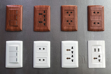Various electrical outlets and switches on display at a hardware store.