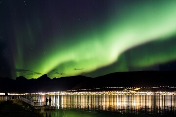Northern Lights over the mountains in Norway during the stary night