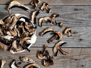 The idea of natural organic ecological products and their preparation for future use for autumn and winter.Autumn wooden background with dried mushrooms.